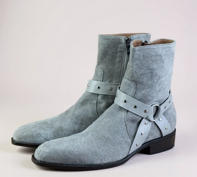 JO Ghost Pair of light blue suede boots with straps on a light gray 